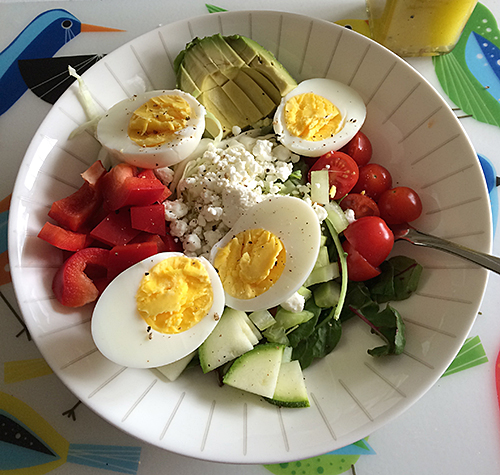 Baby spinach, baby kale, zucchini, red peppers, avocado, celery, cherry tomatoes, hard boiled eggs, goats milk cheese crumbles